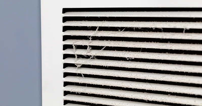 Close-up of a dirty air vent grille