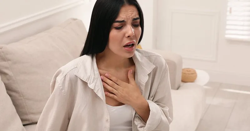 Woman with breathing problems holding her chest