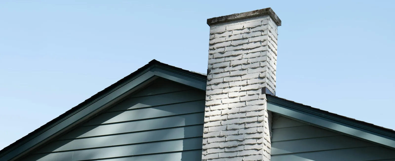 White brick chimney on a house roof